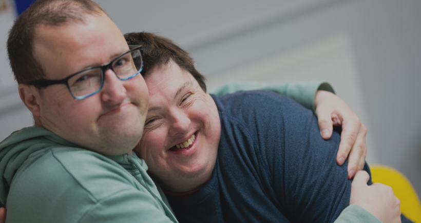 Two people we support at Score have a cuddle. Day Opportunities Centres like Score enable people to build up their social circle in a safe, supportive environment, while enjoying activities and trying new things.